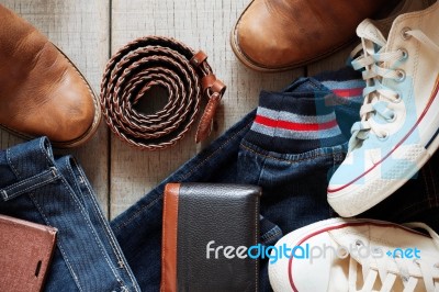 Clothing And Leather On Wooden Floor Stock Photo