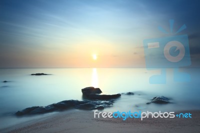 Cloud And Seascape And Rock At Dawn Stock Photo