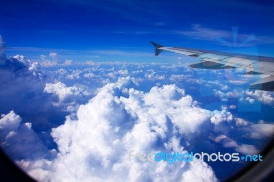 Clouds And Sky As Seen Through Window Of An Aircraft Stock Photo