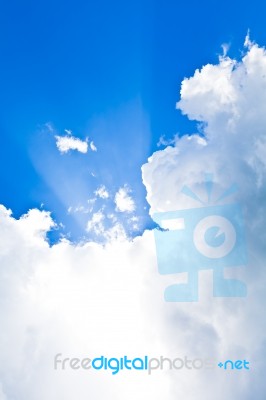 Clouds In Blue Sky With Sunbeam Stock Photo