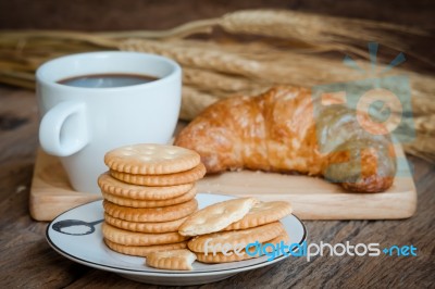 Coconut Creacker ,croissant And Cup Of Coffee On Old Wood Table Stock Photo