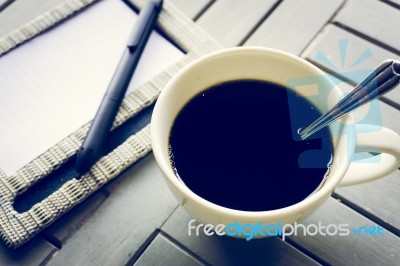 Coffee And Notebook On Wooden Table Stock Photo