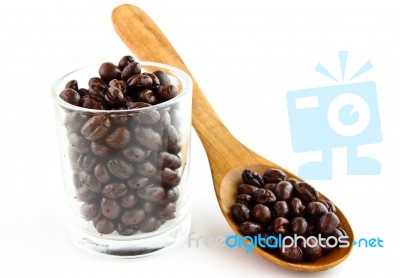 Coffee Beans In Glass And Spoon Stock Photo