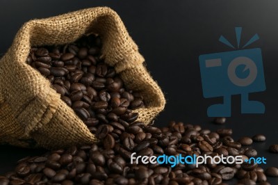 Coffee Beans In Sack On Black Background Stock Photo