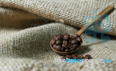 Coffee Beans In Wooden Spoon On Sackcloth Stock Photo