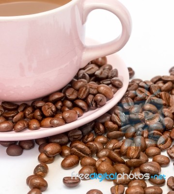 Coffee Beans Next To A Cup Of Freshly Brewed Stock Photo