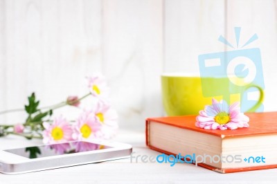 Coffee Cup And Books Or Journal With Flowers Stock Photo