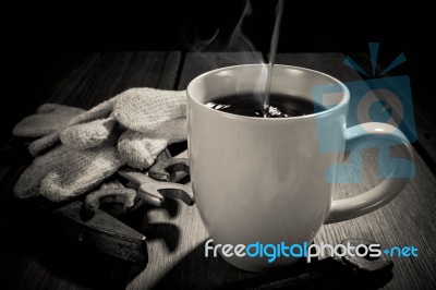 Coffee Cup And Tools On A Wooden Table. Dark Background Stock Photo