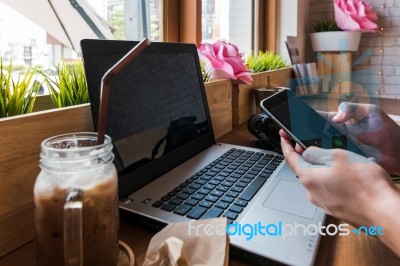 Coffee Cup  On A Table With Laptob And Graph Finance Diagram In Stock Photo