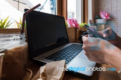 Coffee Cup  On A Table With Laptob And Graph Finance Diagram In Stock Photo