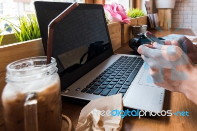 Coffee Cup  On A Table With Laptob And Graph Finance Diagram In Stock Photo