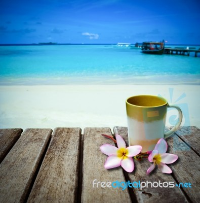 Coffee Cup On Old Wood Table Placed On The Beach Stock Photo