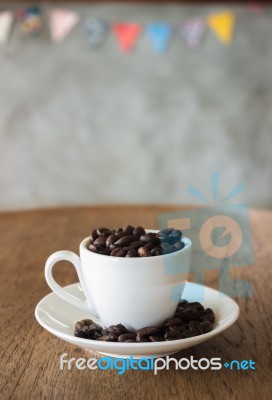 Coffee Cup Or Coffee Beans On Wooden Table In The Coffee Shop Stock Photo