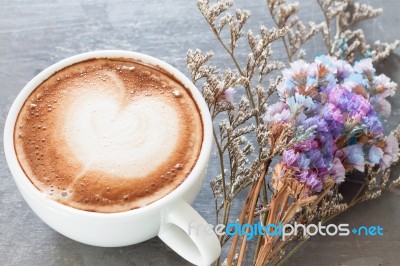 Coffee Cup With Beautiful Violet Flower Stock Photo