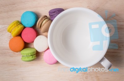 Coffee Cup With Colorful Macarons Stock Photo