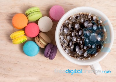 Coffee Cup With Colorful Macarons Stock Photo