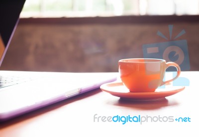 Coffee Cup With Keyboard On Wooden Table Stock Photo