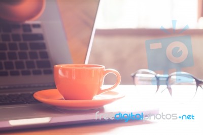 Coffee Cup With Keyboard On Wooden Table Stock Photo