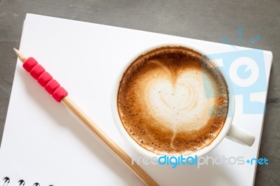 Coffee Cup With Notepad On Grey Background Stock Photo