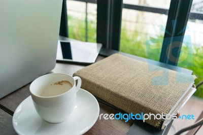 Coffee, Diary Book, Laptop And On Table In Cafe Stock Photo