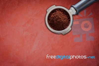 Coffee Grind In Group On Red Concrete Background Stock Photo