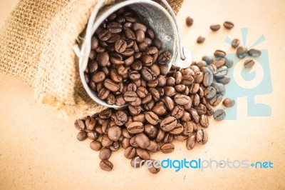 Coffee Roasted Bean In The Bucket On Wooden Background Stock Photo