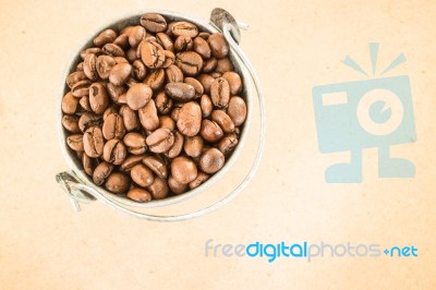 Coffee Roasted Bean In The Bucket On Wooden Background Stock Photo