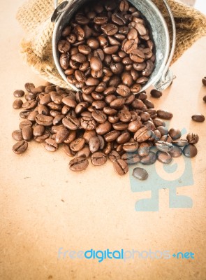 Coffee Roasted Bean In The Bucket On Wooden Background Stock Photo