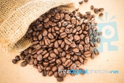 Coffee Roasted Bean In The Sack On Wooden Background Stock Photo