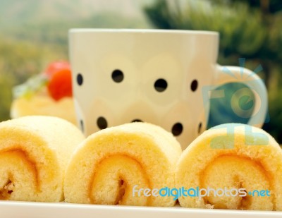 Coffee Swiss Roll Indicates Orange Flavored Cake And Break Stock Photo