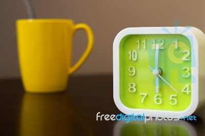 Coffee Time On Morning Before Going Work. Green Alarm Clock With… Stock Photo