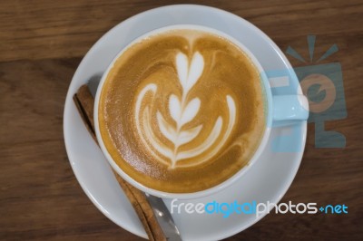 Coffee With Latte Art On Wooden Table Stock Photo