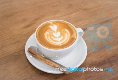 Coffee With Latte Art On Wooden Table Stock Photo