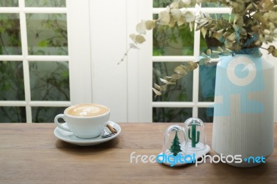 Coffee With Latte Art On Wooden Table Stock Photo