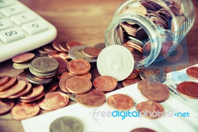 Coins Spilling Out Of A Glass Bottle Vintage Stock Photo