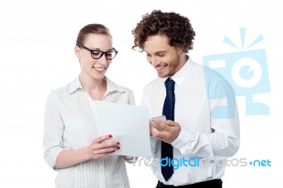 Colleagues Reviewing Business Document Stock Photo