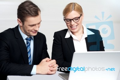 Colleagues Working Together On Laptop Stock Photo