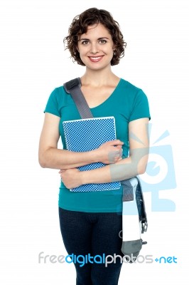 College Student With Stylish Sling Bag And Notebook Stock Photo