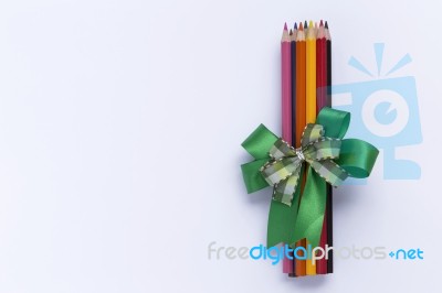 Color Pencil With Green Ribbon Stock Photo