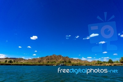 Colorado River And Mountains And Dredging Barge Under Blue Sky Stock Photo