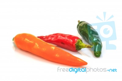 Colored Peppers Over White Background Stock Photo