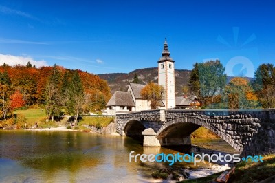 Colorful Autumn Day In Ancient Village With Old Bridge And Churc… Stock Photo