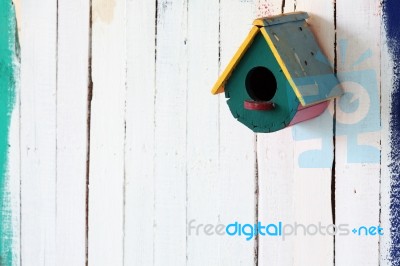 Colorful Bird House On Grunge Wall Stock Photo