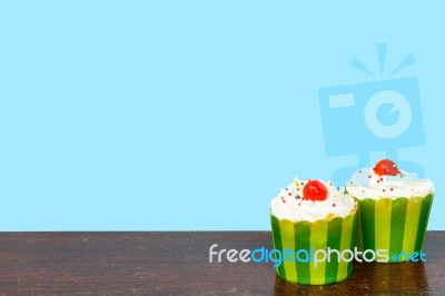 Colorful Cupcakes On A Wooden Background Stock Photo