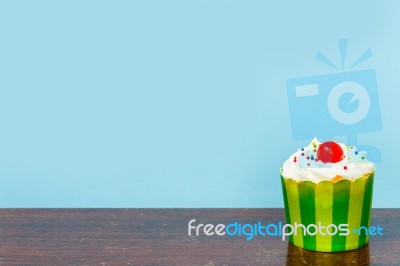 Colorful Cupcakes On A Wooden Background Stock Photo