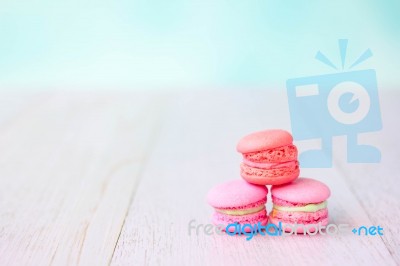 Colorful Macarons On A Pink Wooden Table Stock Photo