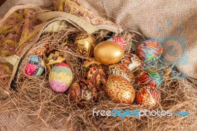 Colorful Painted Easter Egg From Fabric Bag On Hay Stock Photo