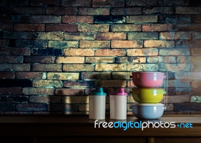 Colorful Tiffin Carrier And Plastic Bottles On Wooden Cupboard W… Stock Photo