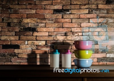 Colorful Tiffin Carrier And Plastic Bottles On Wooden Cupboard W… Stock Photo