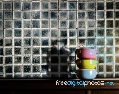 Colorful Tiffin Carrier On Wooden Cupboard Stock Photo